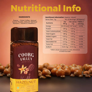 Coorg Valley Vanilla Hazelnut Instant Coffee jar with nutritional info, freeze-dried, surrounded by hazelnuts and coffee beans