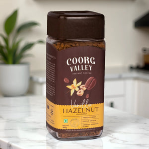 Coorg Valley Vanilla Hazelnut flavored instant coffee jar on white marble kitchen counter