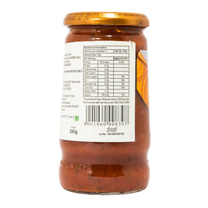 Jar of pasta sauce with label showing nutritional information on a white background