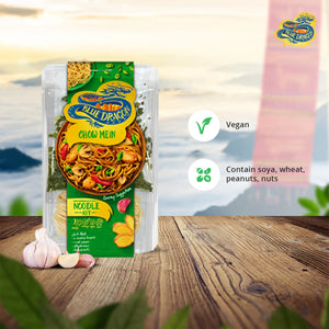 Blue Dragon vegan chow mein noodle kit package on wooden table with garlic and herbs