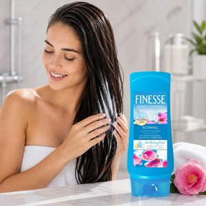 Finesse Normal Conditioner with hyaluronic acid for shine & manageability, shown with woman applying to wet hair