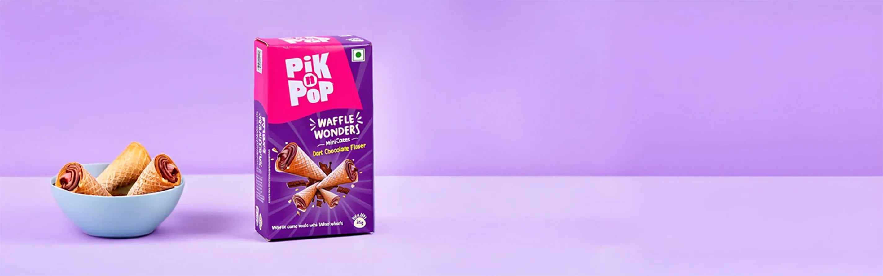 Pik n Pop Waffle Wonders dark chocolate filled mini cones in a blue bowl with purple background