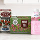 Assorted imported beverages and tea including peach juice, instant coffee, and green tea on display