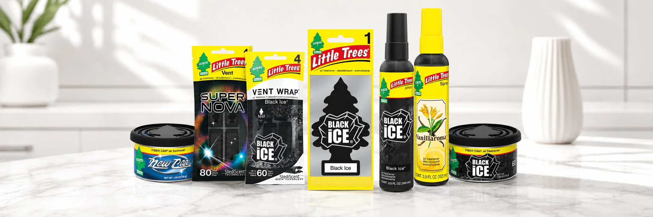 Assorted car air fresheners including Little Trees, spray, and vent clips on a display stand