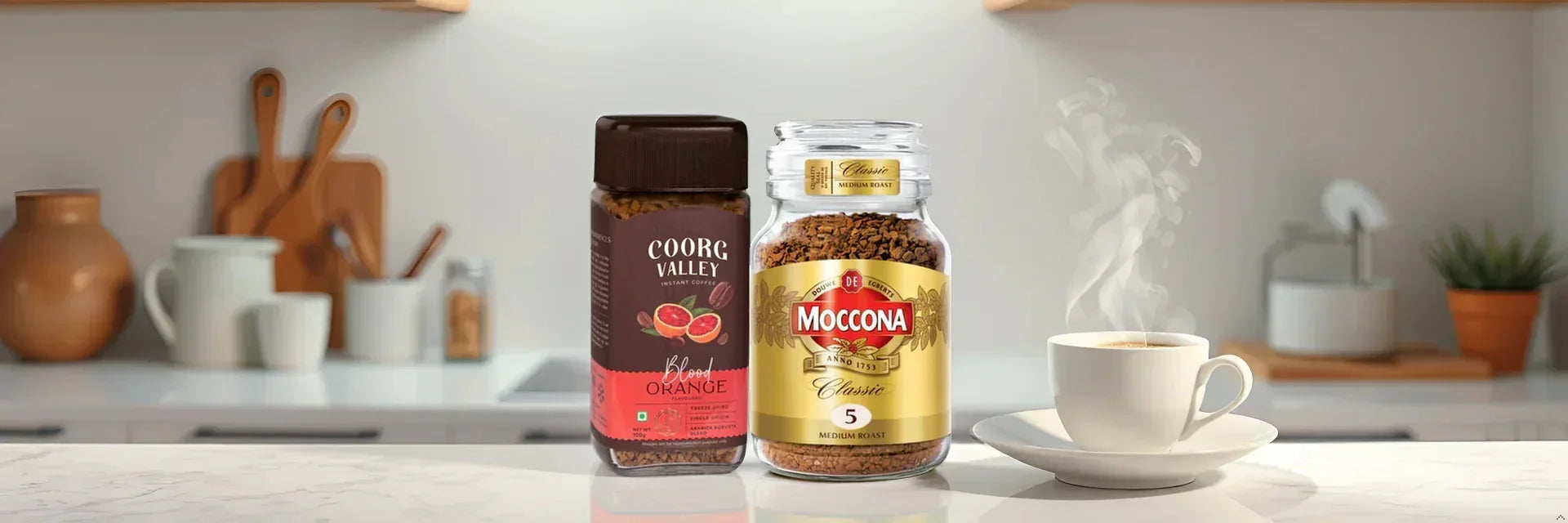 Instant coffee jars of Coorg Valley Blood Orange and Moccona Classic beside a steaming cup in a modern kitchen