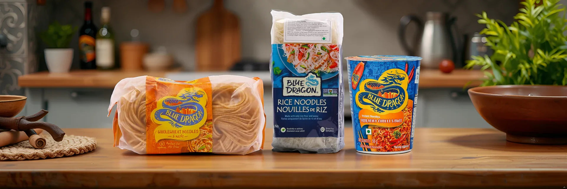 Assorted Blue Dragon noodles including wholewheat, rice, and instant sriracha cup on kitchen counter