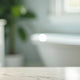 Luxury bath essentials with pump dispensers on marble countertop near freestanding tub