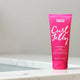 Umberto Giannini Curl Jelly hair product on a white marble bathroom counter