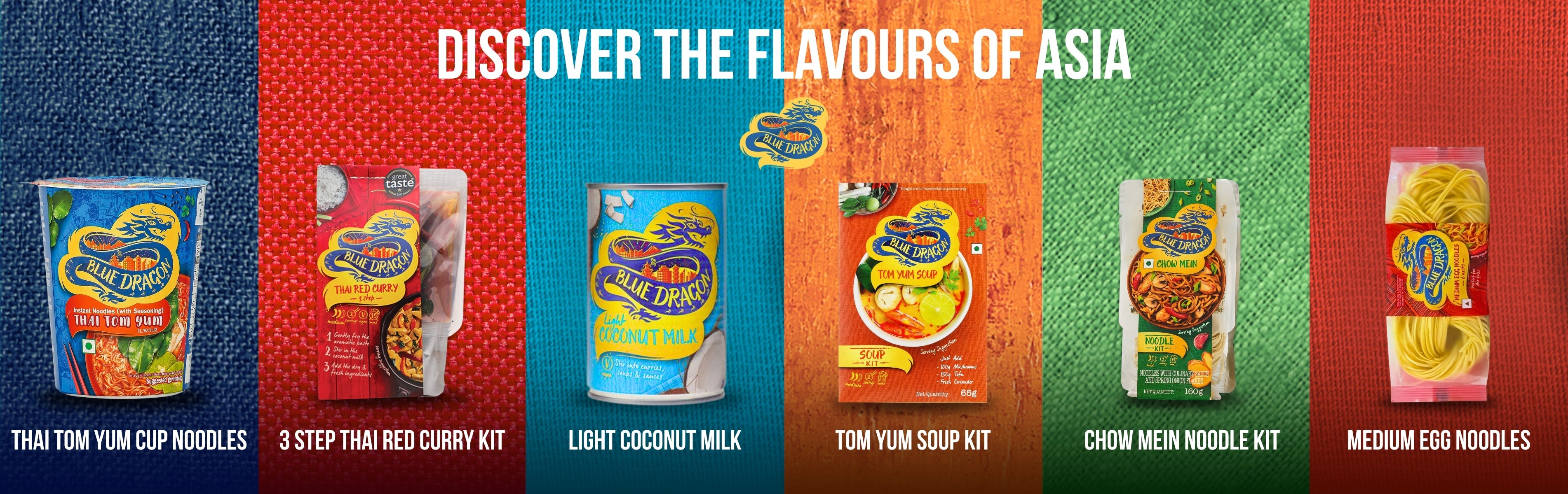 Blue Dragon Asian food products including noodles and sauces displayed by the sea on a wooden surface