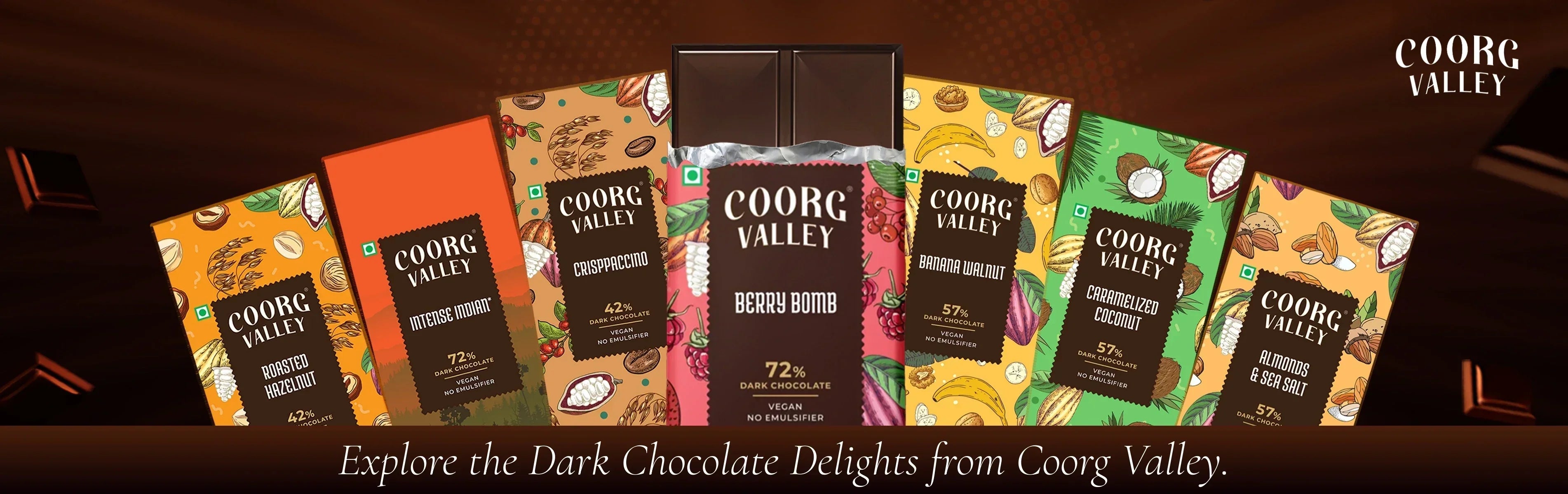 Assorted Coorg Valley dark chocolate bars with colorful packaging on a brown background