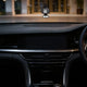 Little Trees Black Ice car air freshener hanging in luxury vehicle interior, iconic scent for cars