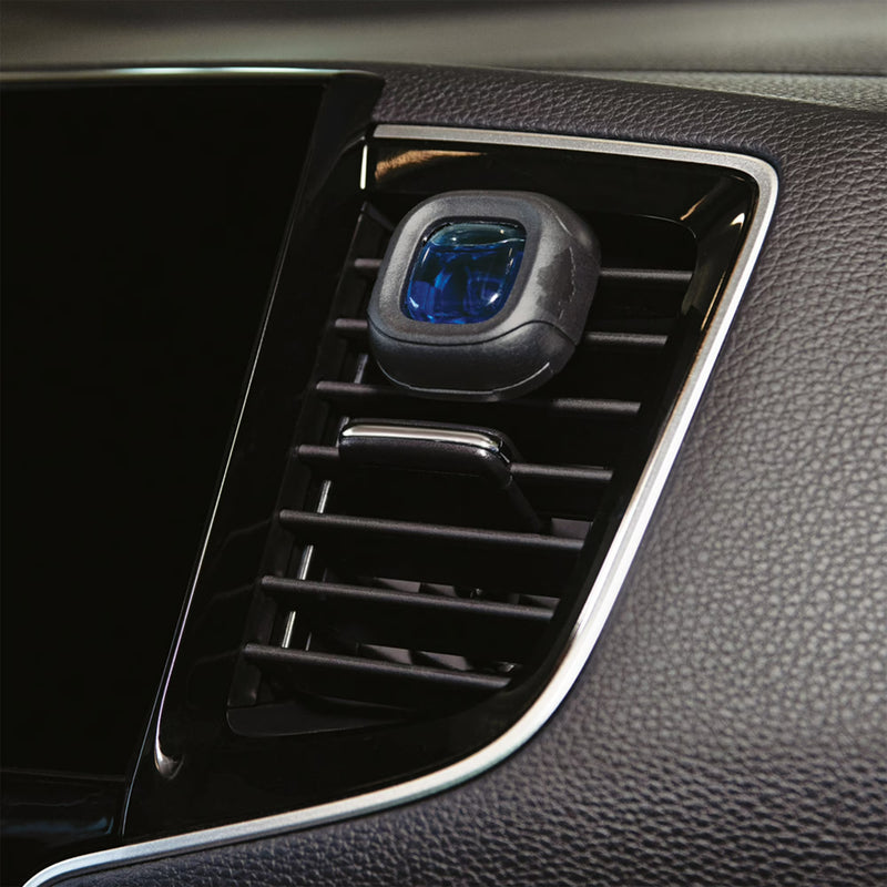 Car air vent with a blue light indicator on a dark interior background