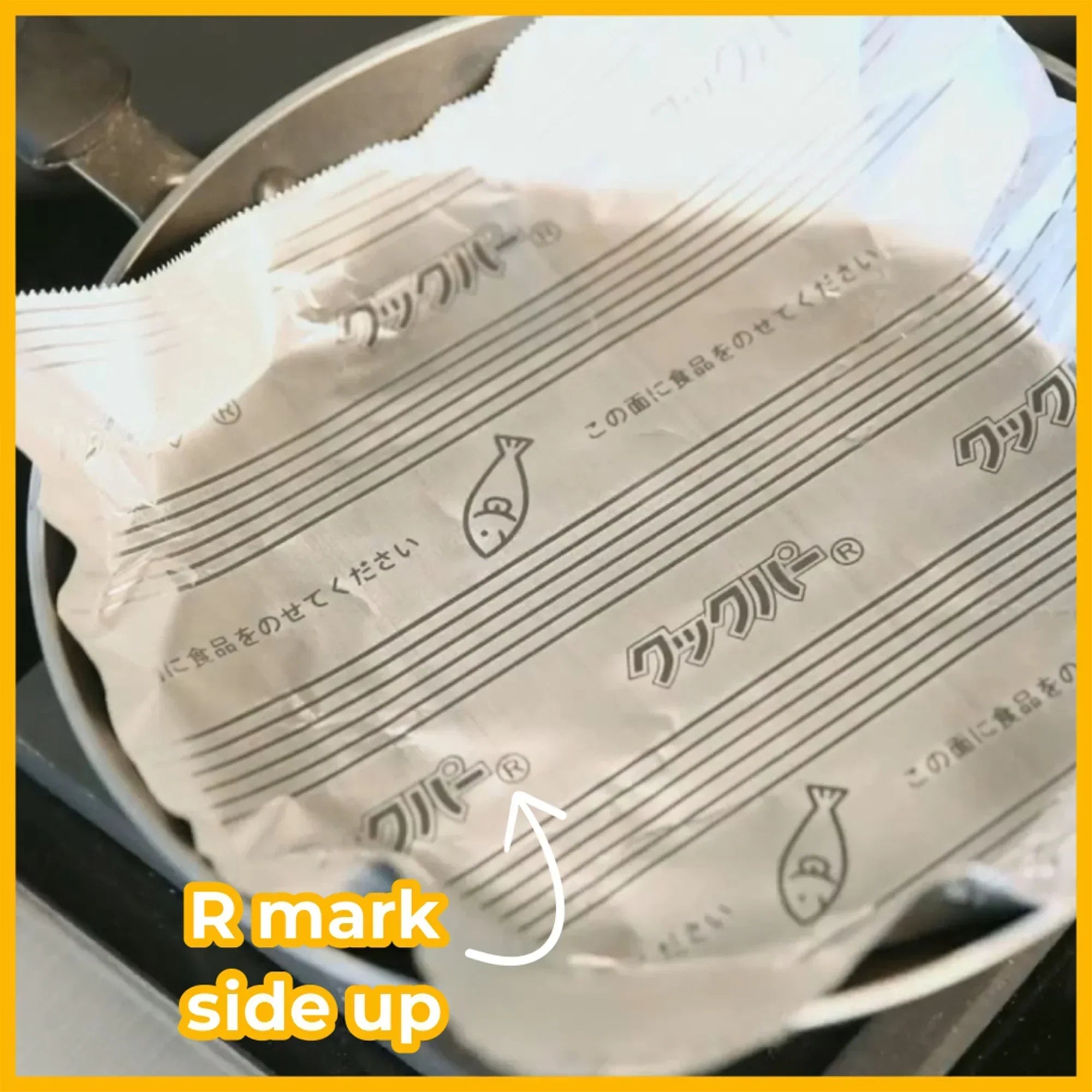 Non-stick frying pan foil sheet with fish icon placed in a metal pan, labeled 'R mark side up'.