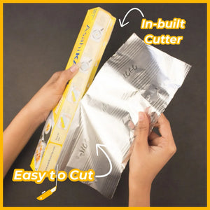 Hands using kitchen foil with in-built cutter, easy to cut, on black surface