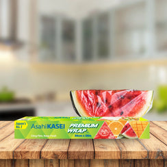 Premium cling film wrap 30cm x 20m box on table with covered watermelon slice