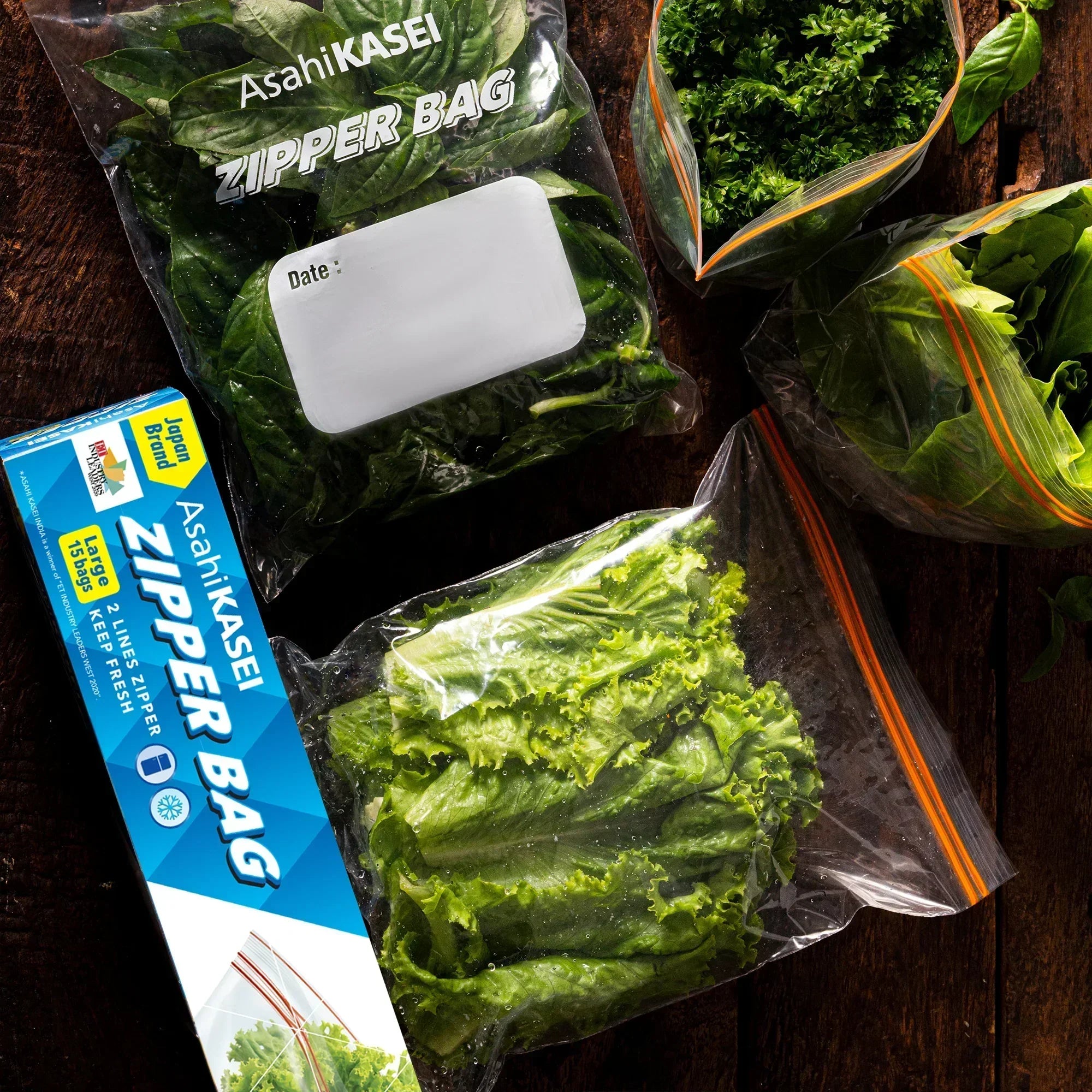 Large Asahi KASEI zipper bags with fresh green leafy vegetables on a wooden table