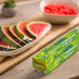 Box of Asahi Kasei premium cling film wrap with sliced watermelon tray on kitchen counter
