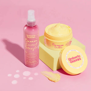 Umberto Giannini Banana Coconut Detangler leave-in conditioner spray and Banana Butter hair treatment on pink background