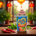 Blue Dragon Thai Tom Yum instant noodles cup on wooden table with red chili peppers and green plants