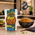 Blue Dragon Pad Thai Noodle Kit with rice noodles, shrimp, and peanuts, served steaming hot in a dragon bowl.