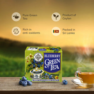 Box of blueberry green tea with fresh blueberries and cup of tea on wooden table