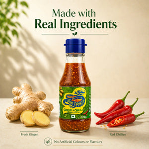 Blue Dragon ginger and chilli sauce bottle with fresh ginger and red chillies