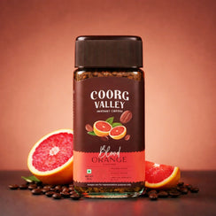 Coorg Valley Blood Orange instant coffee jar with coffee beans and blood orange slices