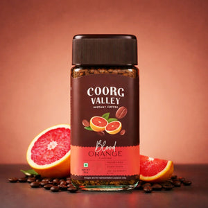 Coorg Valley Blood Orange instant coffee jar with coffee beans and blood orange slices