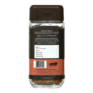 Back view of instant coffee jar with brown label, barcode, and product information visible