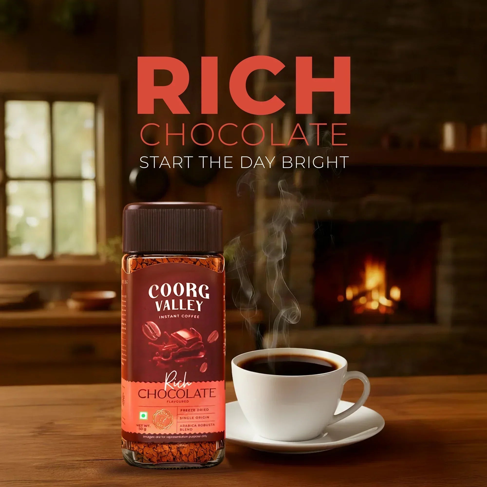 Coorg Valley Rich Chocolate instant coffee jar and steaming coffee cup on table with cozy fireplace background