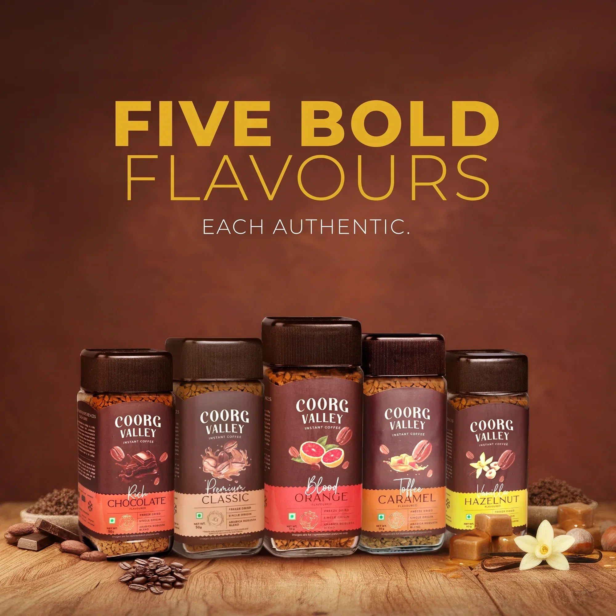 Five jars of Coorg Valley instant coffee in chocolate, classic, orange, caramel, and hazelnut flavors.