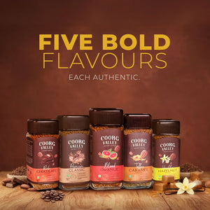 Five jars of Coorg Valley instant coffee in chocolate, classic, orange, caramel, and hazelnut flavors.