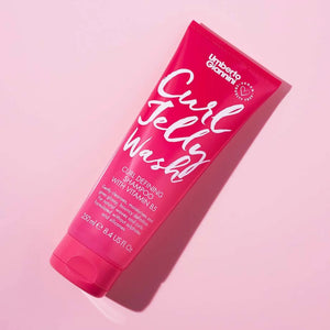 Umberto Giannini Curl Jelly Wash curl defining shampoo with vitamin B5 in pink tube on pink background