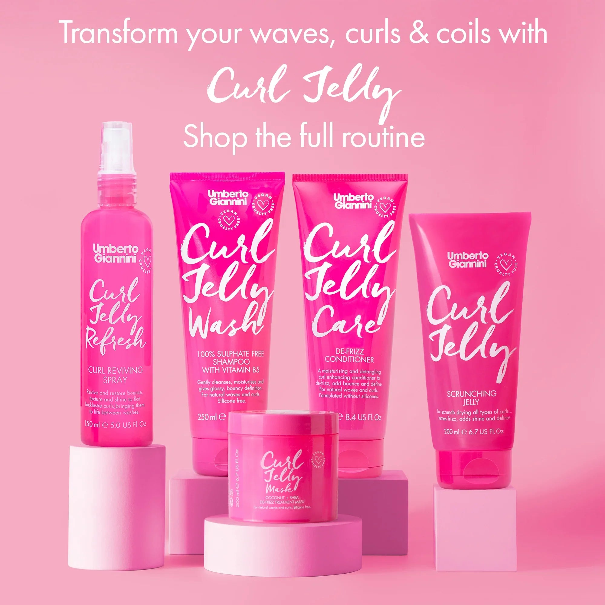 Umberto Giannini Curl Jelly haircare range including curl reviving spray, shampoo with vitamin B5, conditioner, scrunching jelly, and coconut shea mask on pink background