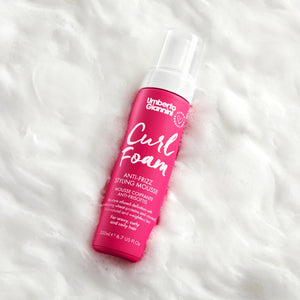 Umberto Giannini Curl Foam anti-frizz styling mousse bottle on white foam background