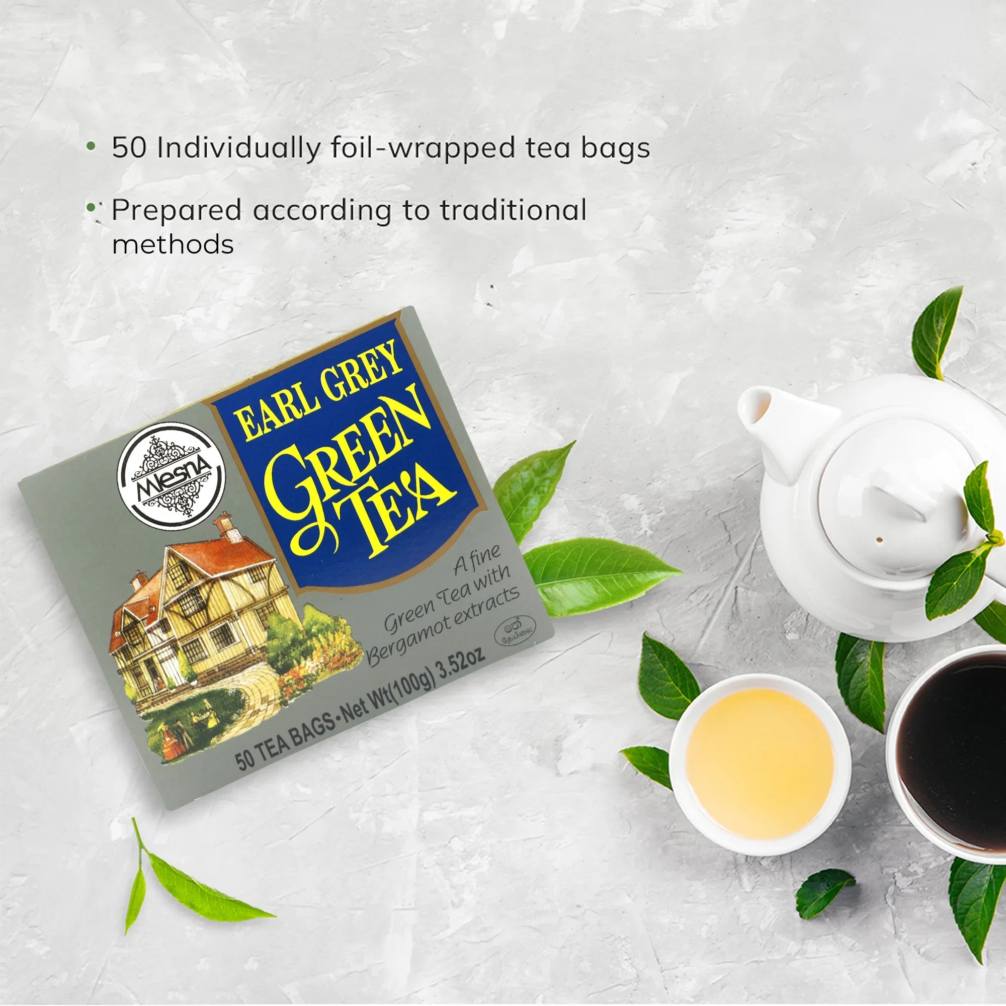 Earl Grey green tea box with teapot, tea cups, and green tea leaves on a light background