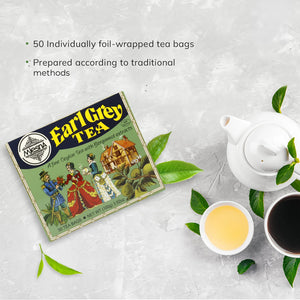 Earl Grey tea box with traditional artwork, teapot, cups of tea, and fresh tea leaves on table