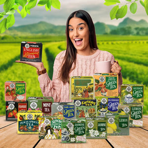 Woman holding a box of English Breakfast Tea with assorted tea boxes on a wooden table, tea plantation background