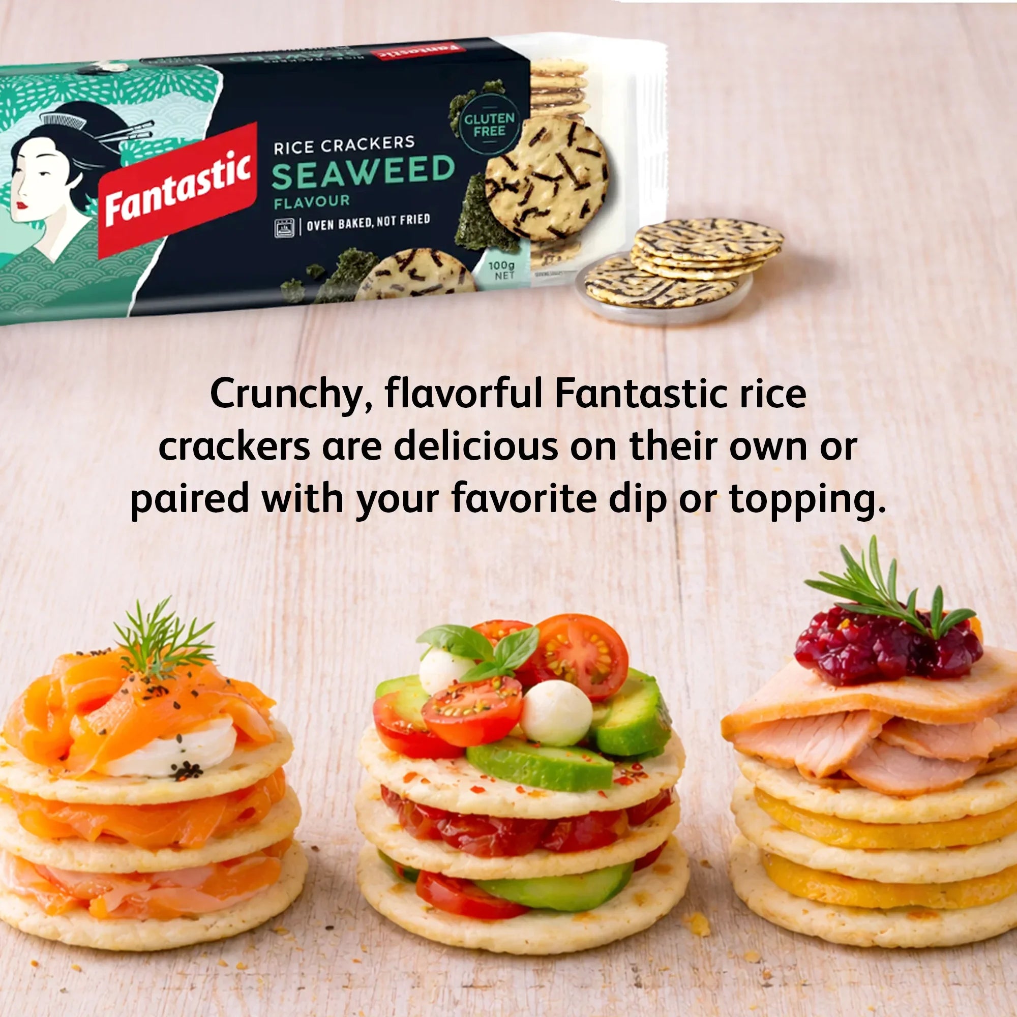 Fantastic seaweed rice crackers with gourmet toppings, gluten free snack on wooden table.