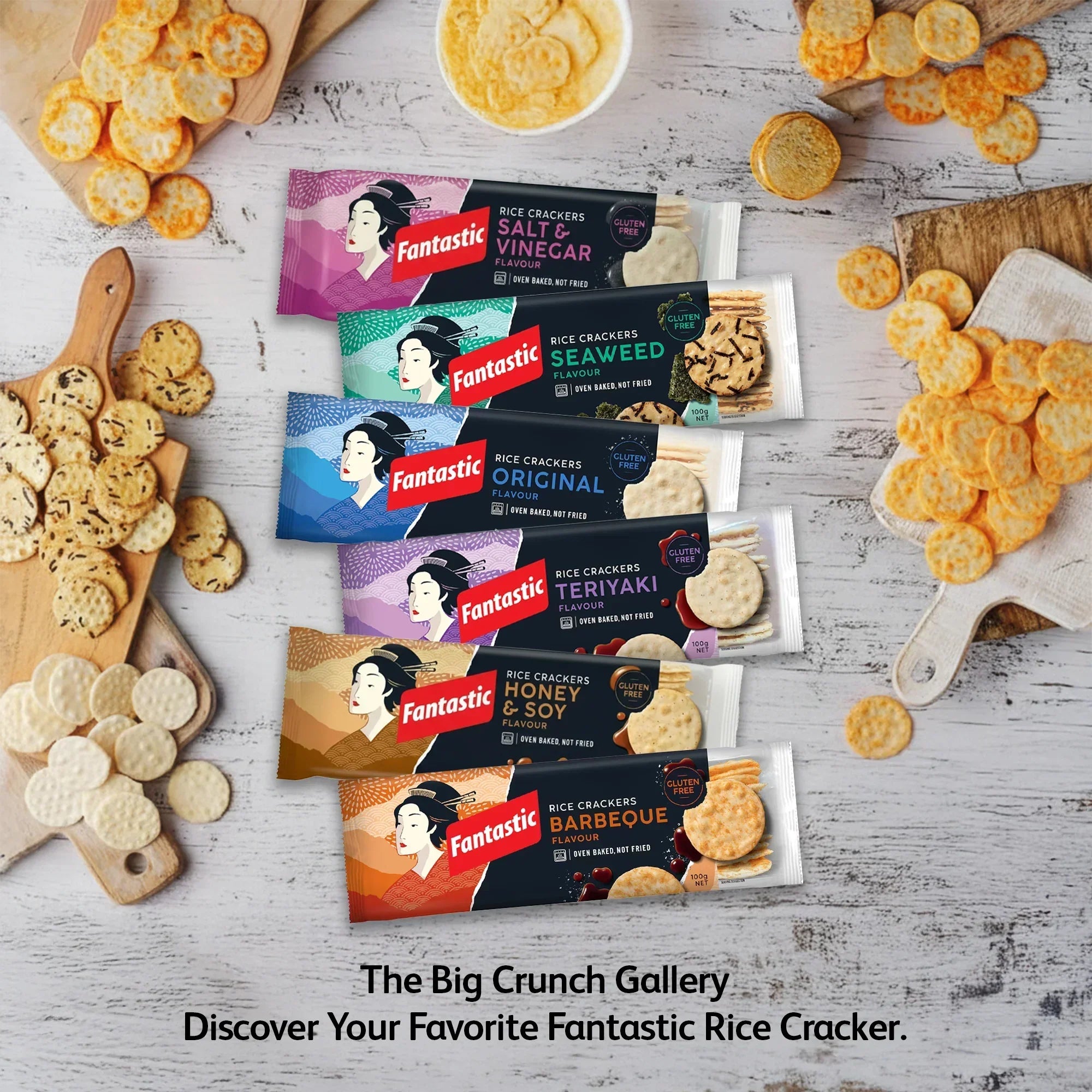 Assorted Fantastic rice cracker snack packs in various flavors on a rustic wooden table with crackers displayed.