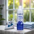 Faultless Heavy Finish ironing spray starch can with iron and neatly folded shirts on ironing board by sunlit window