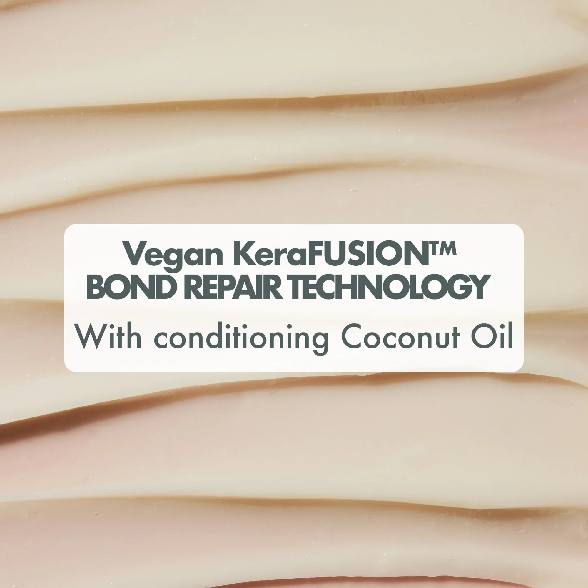 Close-up of creamy textured product with text highlighting vegan KeraFUSION bond repair technology and conditioning coconut oil
