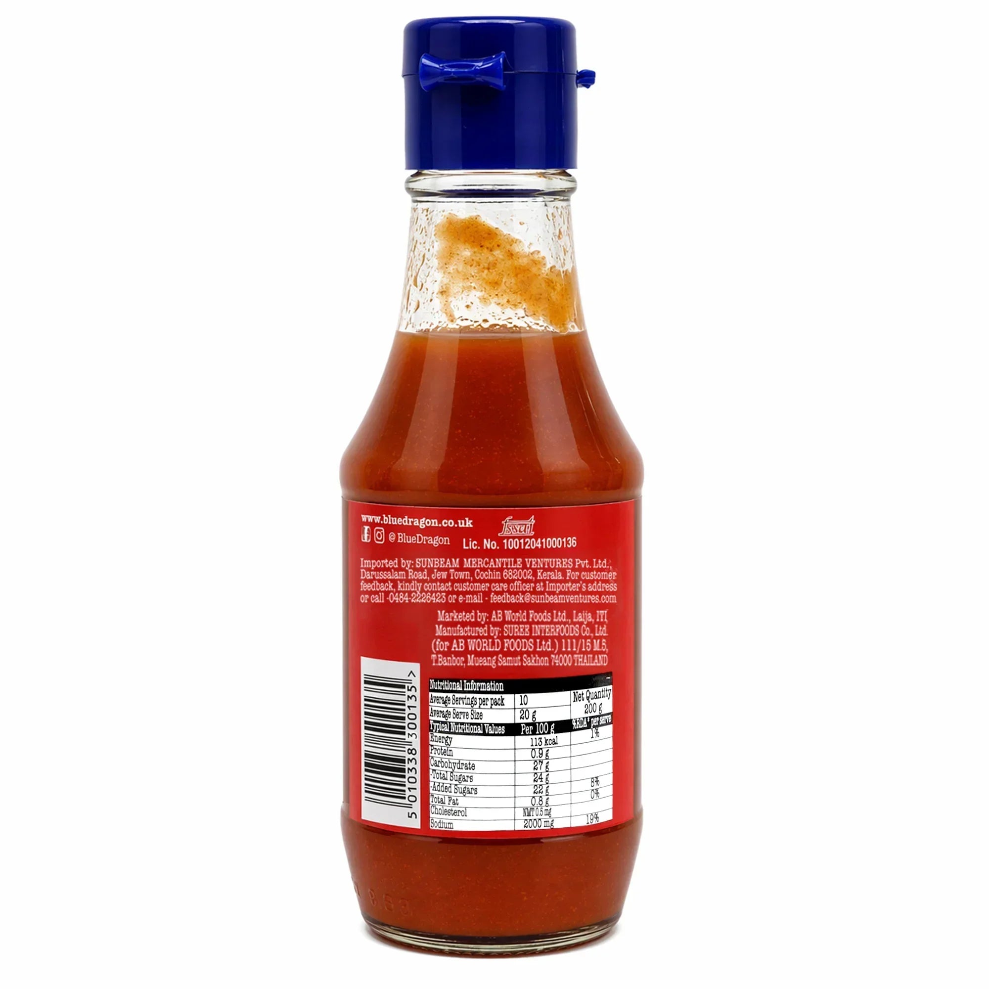 Bottle of hot chili sauce with blue cap, red label, and nutritional info on the back