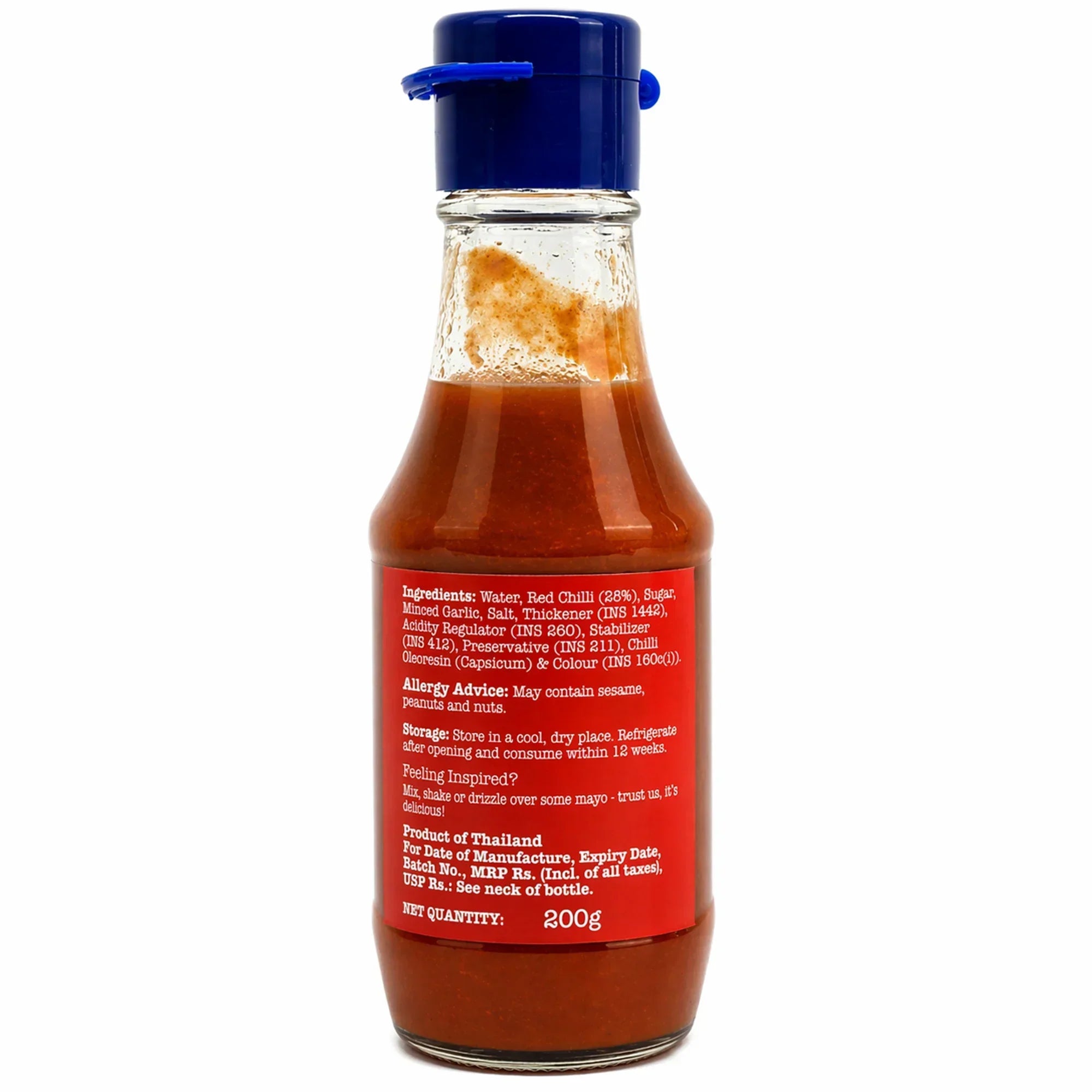 Glass bottle of hot chili sauce with blue cap and red label showing ingredients and usage instructions
