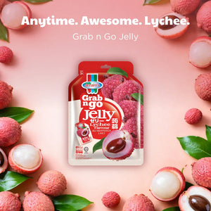 Grab n Go lychee flavoured jelly pouch surrounded by fresh lychees and leaves on a pink background