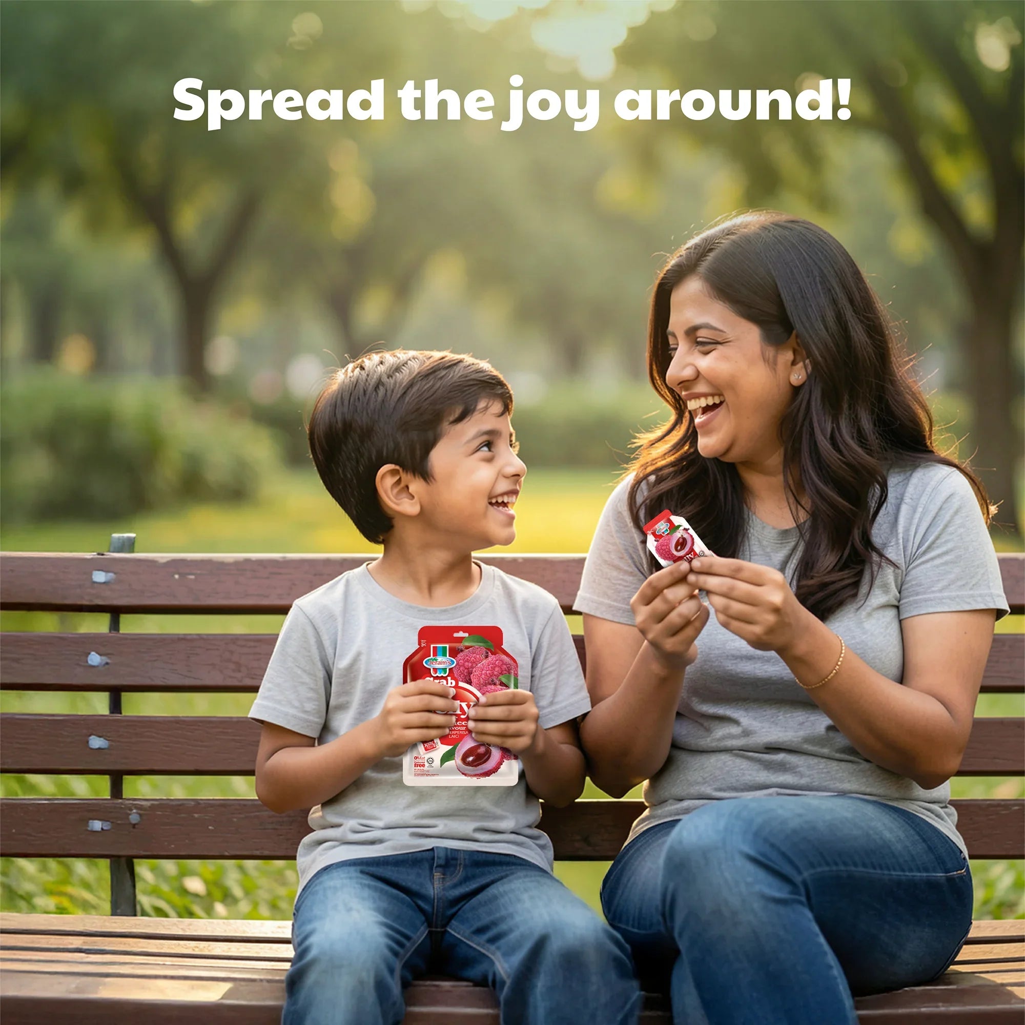 Smiling woman and boy sitting on park bench enjoying lychee flavoured jelly snacks