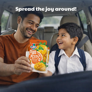Man and child in a car smiling, holding Grab n Go mango flavoured jelly snack
