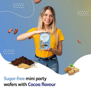 Woman holding a pack of sugar-free mini cocoa party wafers with cocoa powder and wafers on display.