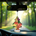 Little Trees Crisp Autumn Air car freshener with colorful leaves hanging from a rearview mirror