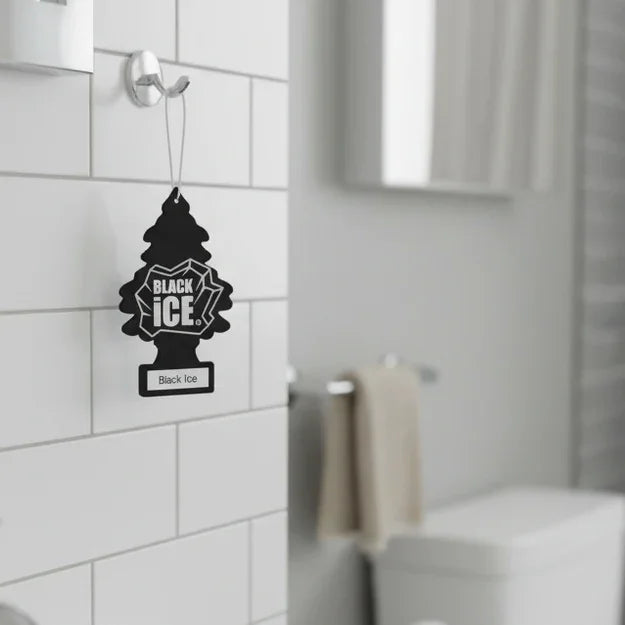 Black Ice tree-shaped air freshener hanging in a modern white tiled bathroom